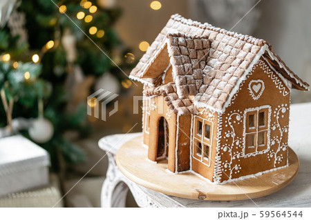 Gingerbread house, concept holiday of Christmas and Happy new year. Defocused lights of Christmas Gingerbread house, concept holiday of Christmas and Happy new year. Defocused lights of Christmas 59564544