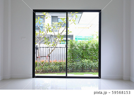slide glass door with small garden landscaping in front of a new house 59568153