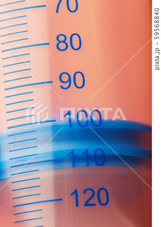 Large medical syringe on pink background with 59568840