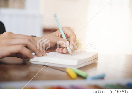 Close up female hands with pen writing on 59568917