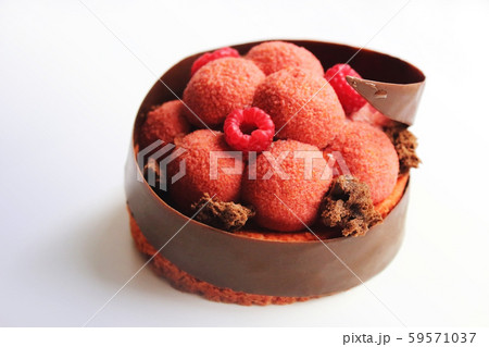Big textured raspberry dessert with chocolate border and fresh berries on white background Big textured raspberry dessert with chocolate border and fresh berries on white background 59571037