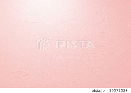 塗り壁のテクスチュア 薄いピンクの背景 の写真素材