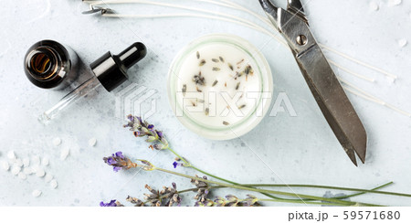 A panorama of a handmade lavender scented candle with essential oil, flowers, wax, wicks, and 59571680