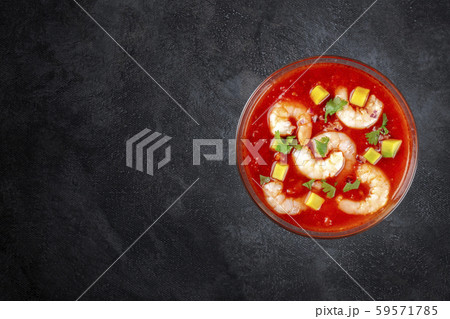 Coctel de camarones, Mexican prawn cocktail with avocado, top-down shot on a dark background with a Coctel de camarones, Mexican prawn cocktail with avocado, top-down shot on a dark background with a 59571785