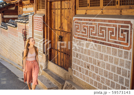 Young woman tourist in Bukchon Hanok Village is one of the famous place for Korean traditional Young woman tourist in Bukchon Hanok Village is one of the famous place for Korean traditional 59573143