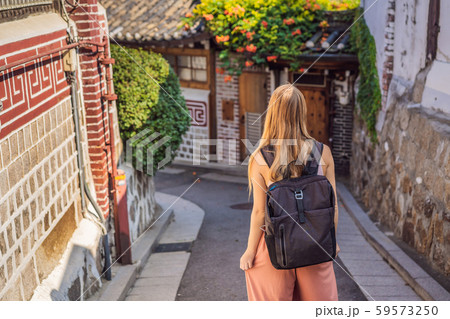 Young woman tourist in Bukchon Hanok Village is one of the famous place for Korean traditional Young woman tourist in Bukchon Hanok Village is one of the famous place for Korean traditional 59573250