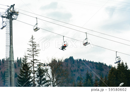 Ski slope with lift on the background of evergreen Carpathian forest, Bukovel resort, Carpathians 59580602