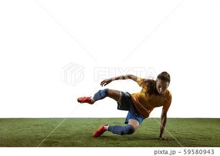 Female soccer player kicking ball at the stadium 59580943