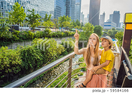 Mom and son tourists in Cheonggyecheon stream in Seoul, Korea. Cheonggyecheon stream is the result 59584166