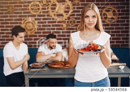 Cute friends in a cafe eatting a pizza Cute friends in a cafe eatting a pizza 59584568