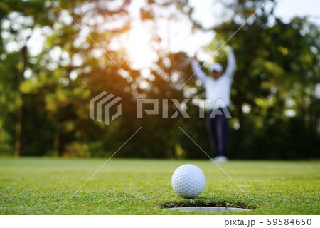 Blurred golfer playing golf in the evening golf Blurred golfer playing golf in the evening golf 59584650