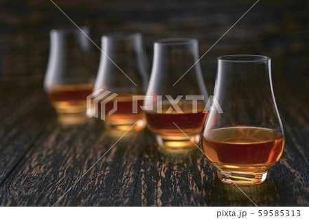 glasses of single malt whiskey on rustic wooden glasses of single malt whiskey on rustic wooden 59585313