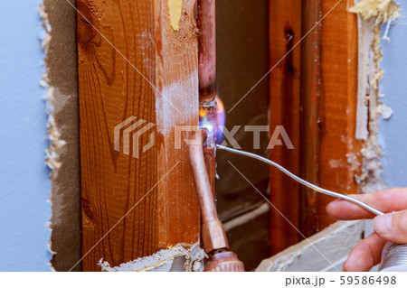 Closeup professional master plumber holding flux Closeup professional master plumber holding flux 59586498