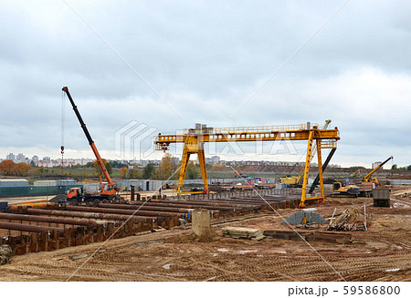 Excavator and autocrane working at construction of a new metro line 59586800