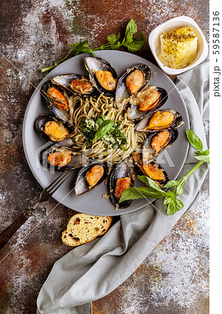 Top view Delicious seafood pasta. Fresh mussels and pesto pasta. Mediterranean Kitchen. Vertical Top view Delicious seafood pasta. Fresh mussels and pesto pasta. Mediterranean Kitchen. Vertical 59587136