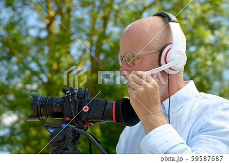 man with headphones, using a camera dslr man with headphones, using a camera dslr 59587687