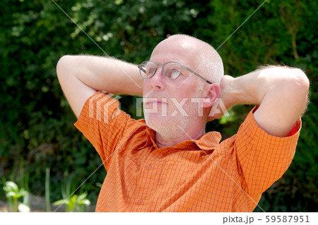 Portrait of a mature man relaxing in the garden Portrait of a mature man relaxing in the garden 59587951