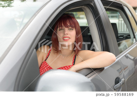 Smiling woman sitting in car Smiling woman sitting in car 59588169