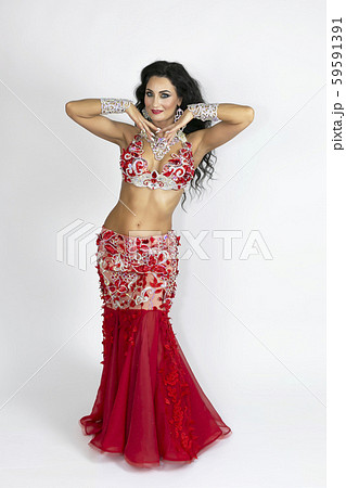 Girl in a red dress for oriental dancing. Girl in a red dress for oriental dancing. 59591391
