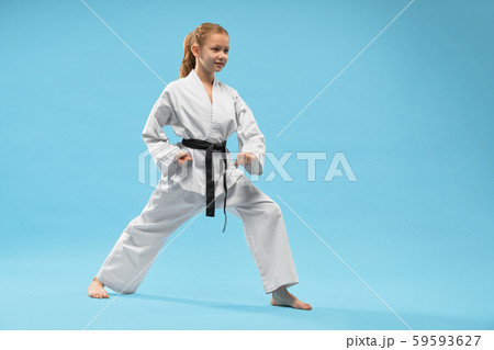Girl performing defense position of karate. 59593627