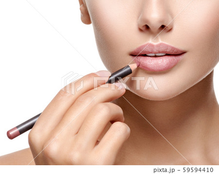 Beautiful woman applying lipstick with cosmetic 59594410