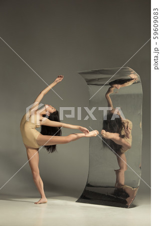 Young and stylish modern ballet dancer on brown background Young and stylish modern ballet dancer on brown background 59609083