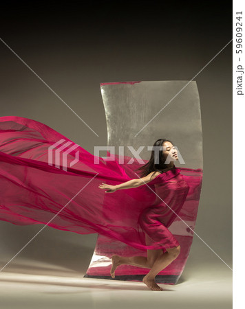 Young and stylish modern ballet dancer on brown background Young and stylish modern ballet dancer on brown background 59609241