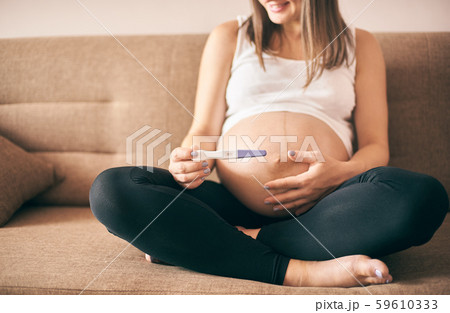Closeup of pregnancy test in hands of young woman 59610333
