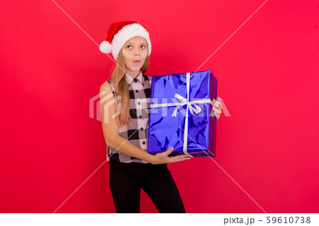 Cute little girl wearing Christmas hat standing 59610738