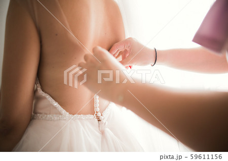 Beautiful bride wearing fashion wedding dress with feathers with luxury delight make-up and 59611156