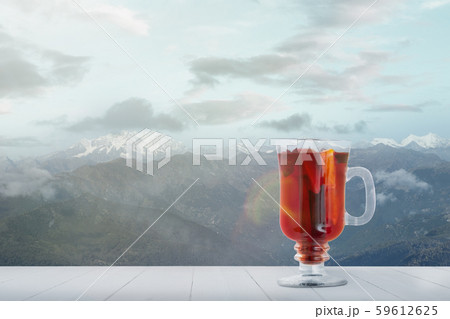 Mulled wine and landscape of mountains on background Mulled wine and landscape of mountains on background 59612625