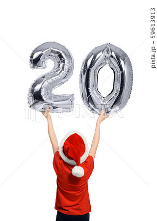 Boy in Santa hat holds up silver inflatable digit 59613913