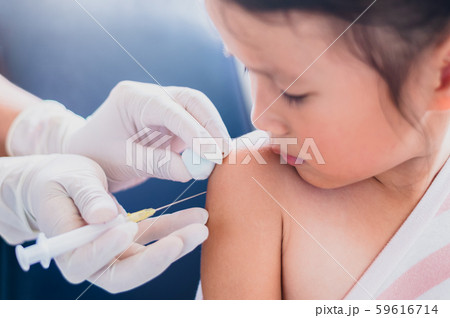 Little child having Injection,Close-up Doctor injecting vaccination to arm of asian little girl Little child having Injection,Close-up Doctor injecting vaccination to arm of asian little girl 59616714