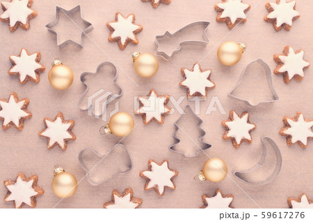 christmas background with kitchen tools, star cookies and baubles on baking paper 59617276
