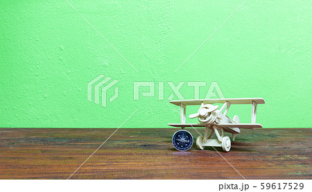 Wood airplane with compass on wooden plank Green Wood airplane with compass on wooden plank Green 59617529