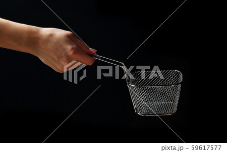 Hand holding metallic basket for french fries 59617577