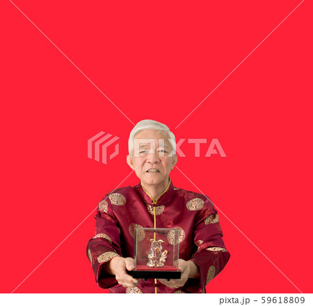 Asian senior man give gold pig sculpture for Chinese new year Asian senior man give gold pig sculpture for Chinese new year 59618809