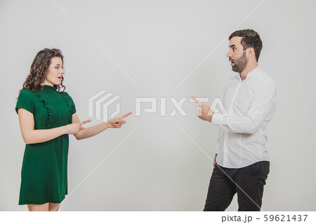 Portrait of business couple struck by the information or product they are pointing at, isolated over Portrait of business couple struck by the information or product they are pointing at, isolated over 59621437