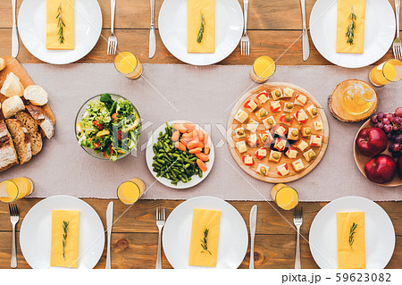 Holiday table setting on wooden surface with tablecloth 59623082