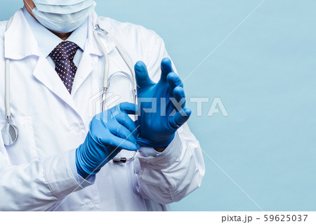 doctor puts on rubber gloves, healthcare and medicine. Isolate on blue background 59625037