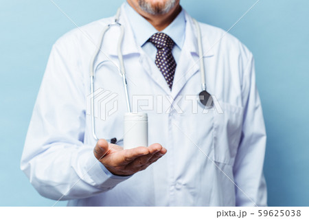 doctor holding bottle of pills on white background. The concept of medicine, pharmacology doctor holding bottle of pills on white background. The concept of medicine, pharmacology 59625038