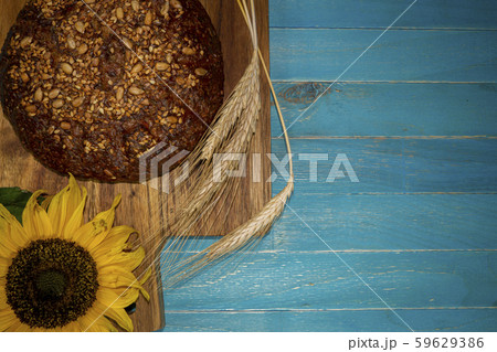 Bread with sunflowers on blue rustic wooden table 59629386