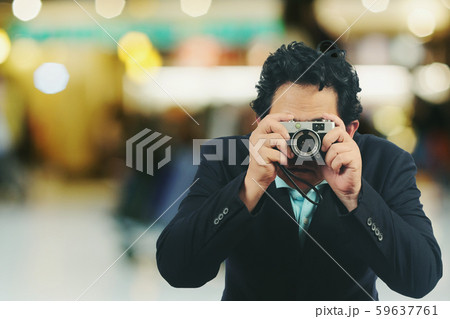 Businessmen take a photo with vintage camera. Businessmen take a photo with vintage camera. 59637761