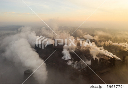Aerial view. Pipes Throwing Smoke in the Sky. Large Plant on the Background of the City. Aerial view. Pipes Throwing Smoke in the Sky. Large Plant on the Background of the City. 59637794