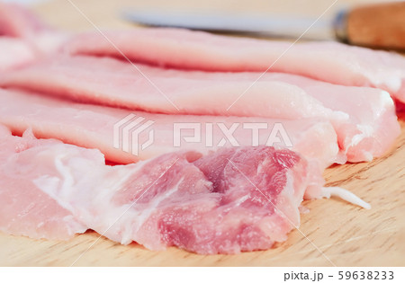 Uncooked slies of fresh pock meat on wood 59638233