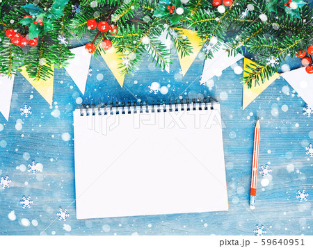 Top view of Christmas background with blank open notepad, pencil and christmas decorations Top view of Christmas background with blank open notepad, pencil and christmas decorations 59640951