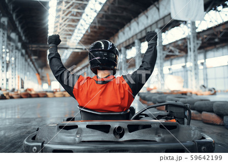 Go kart racer raised his hands up, winner, karting Go kart racer raised his hands up, winner, karting 59642199