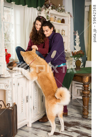 cheerful young couple posing sitting on a dresser cheerful young couple posing sitting on a dresser 59642568