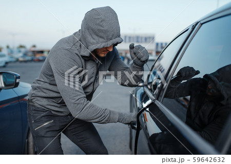 Car thief breaking door lock, criminal job 59642632
