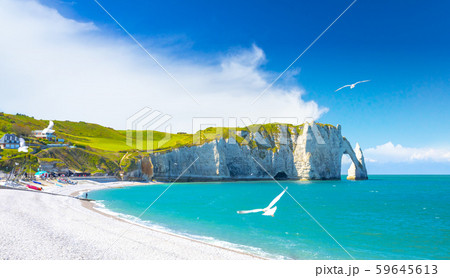 Picturesque panoramic landscape on the cliffs of Etretat. Natural amazing cliffs. Etretat, Normandy, France, La Manche or English Channel. Coast of the Pays de Caux area in sunny summer day. France Picturesque panoramic landscape on the cliffs of Etretat. Natural amazing cliffs. Etretat, Normandy, France, La Manche or English Channel. Coast of the Pays de Caux area in sunny summer day. France 59645613